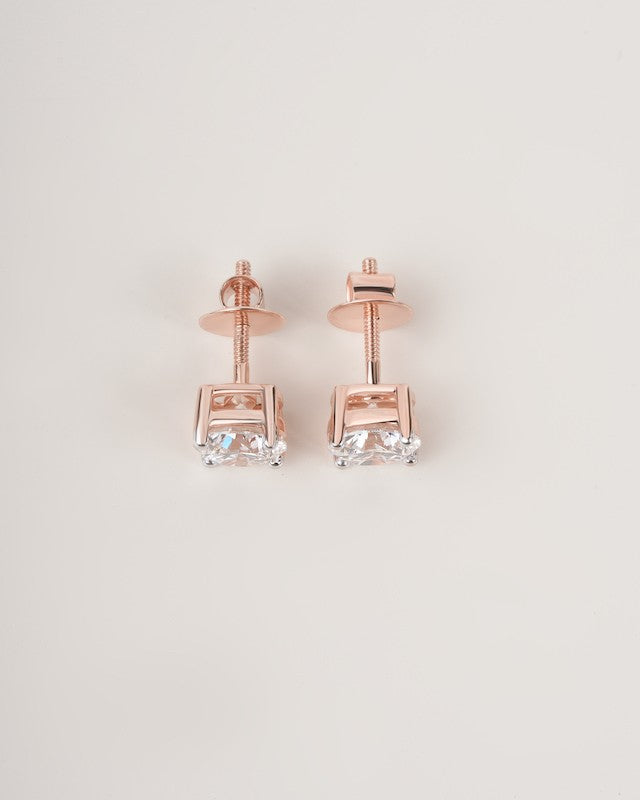 Rose gold diamond solitaire stud earrings on a white background.