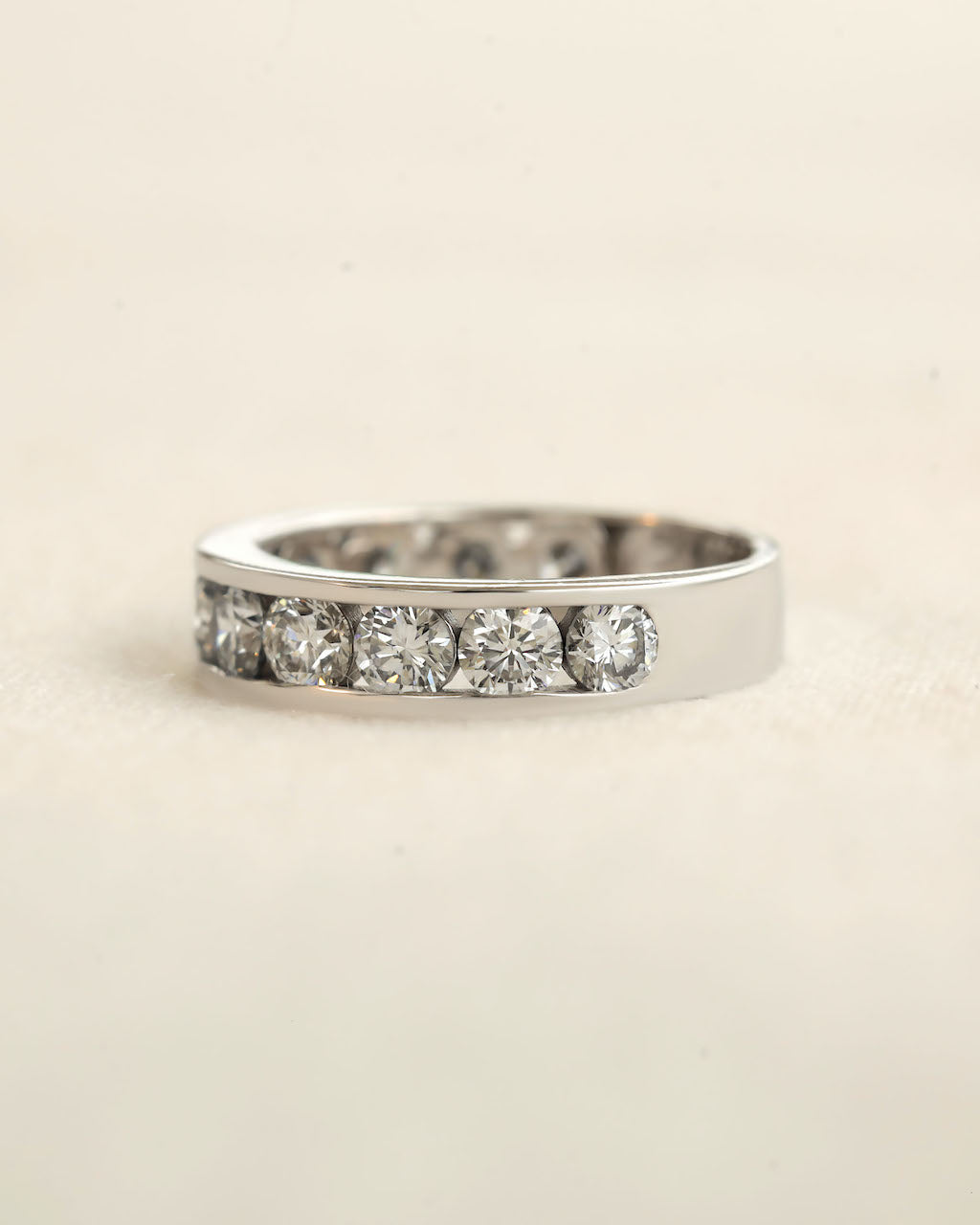 Side view of channel set diamond eternity ring in white gold.