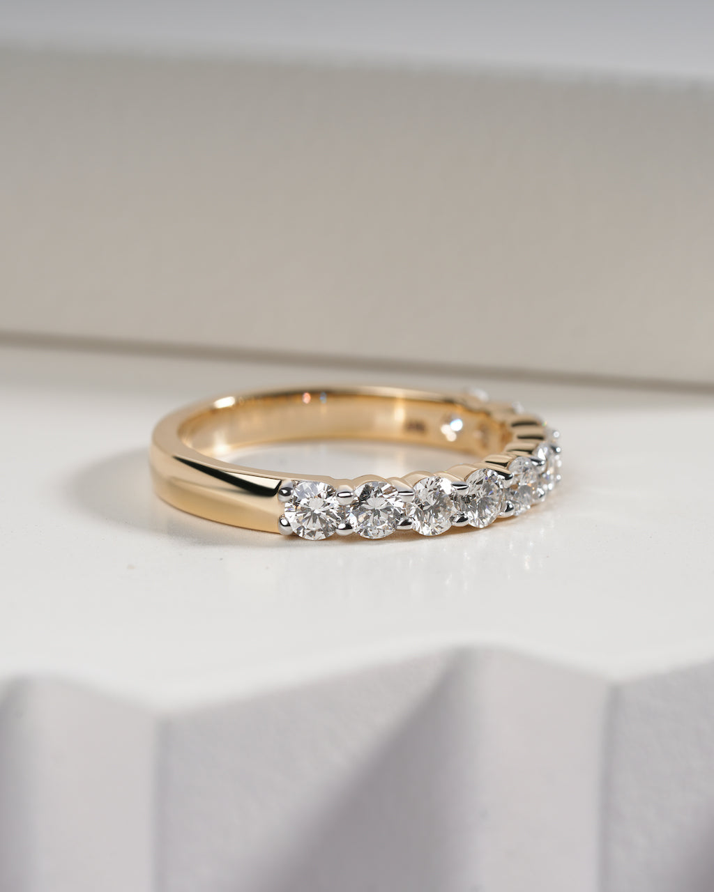Gold ring with diamonds on a white background.