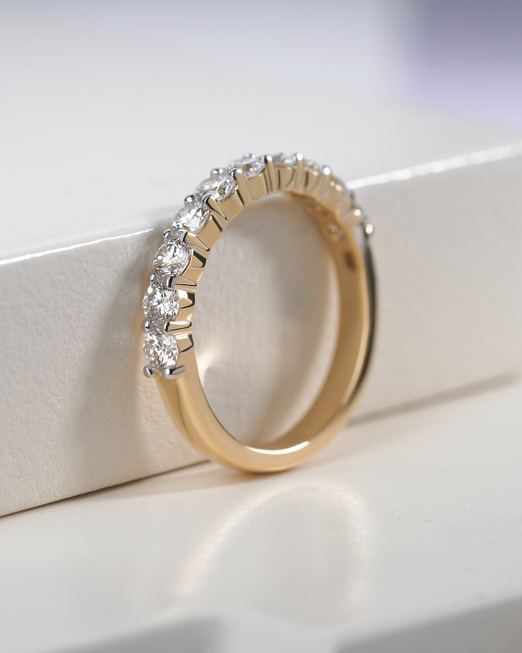 Gold ring with diamonds on a white background.