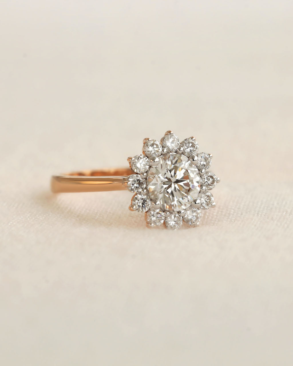 Diamond ring on a beige fabric background.