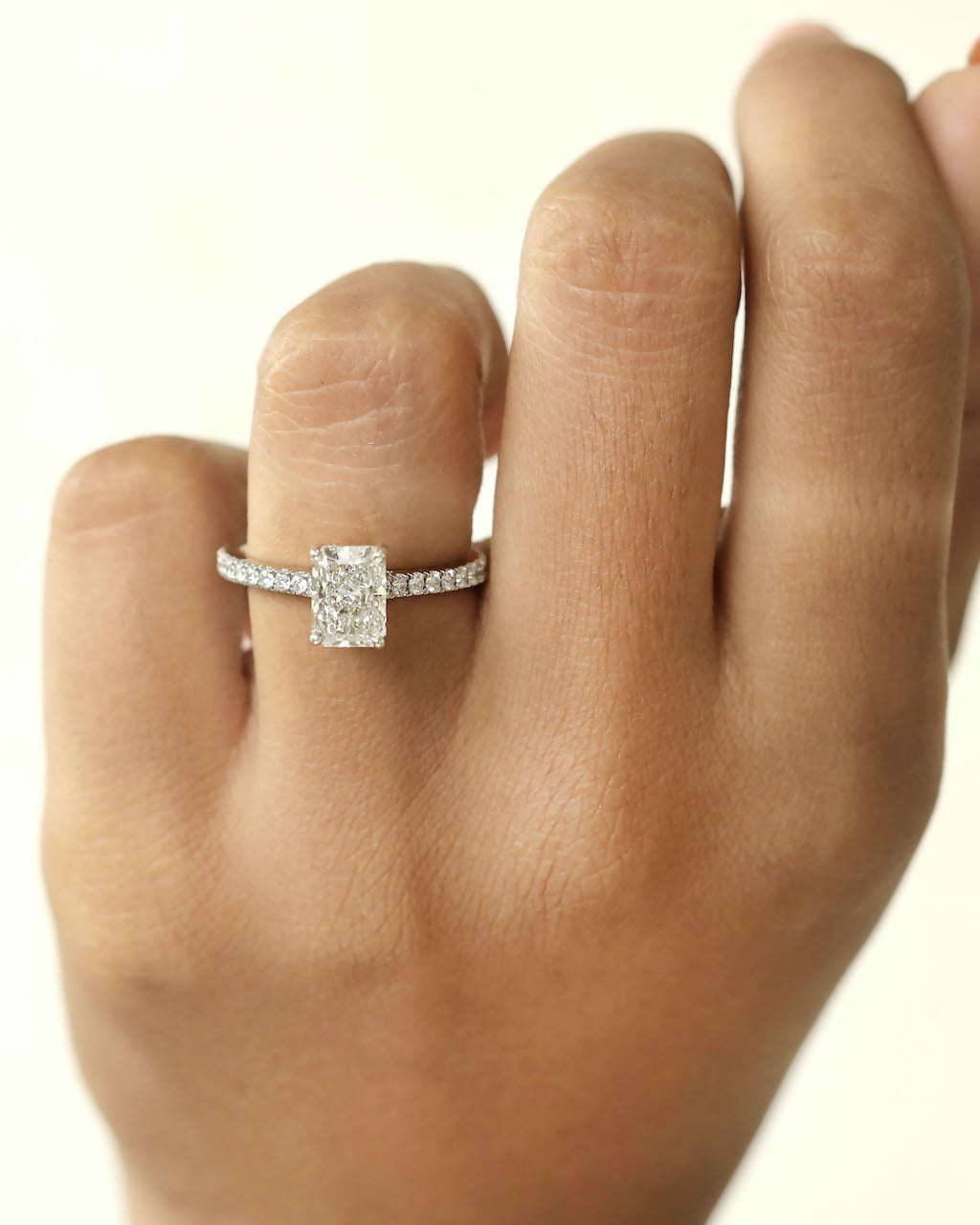 Diamond ring on a hand against a white background