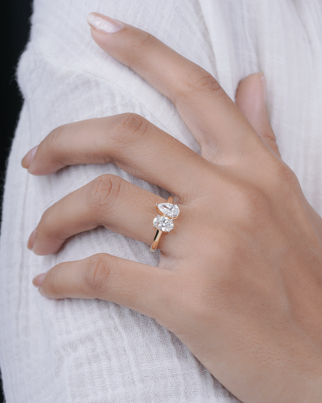 Hand wearing a diamond ring on a white background