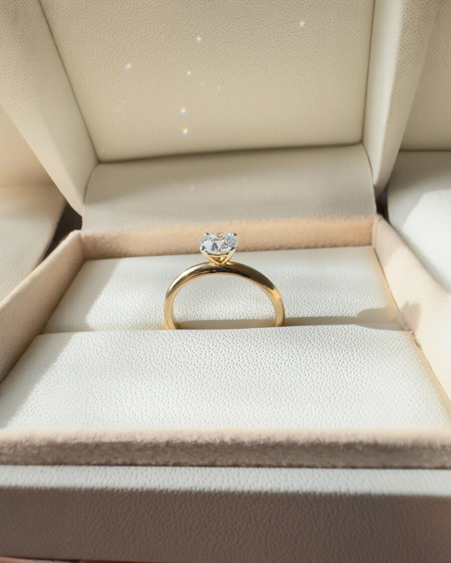 Close up of round brilliant diamond engagement ring.