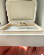 Close up of round brilliant diamond engagement ring.