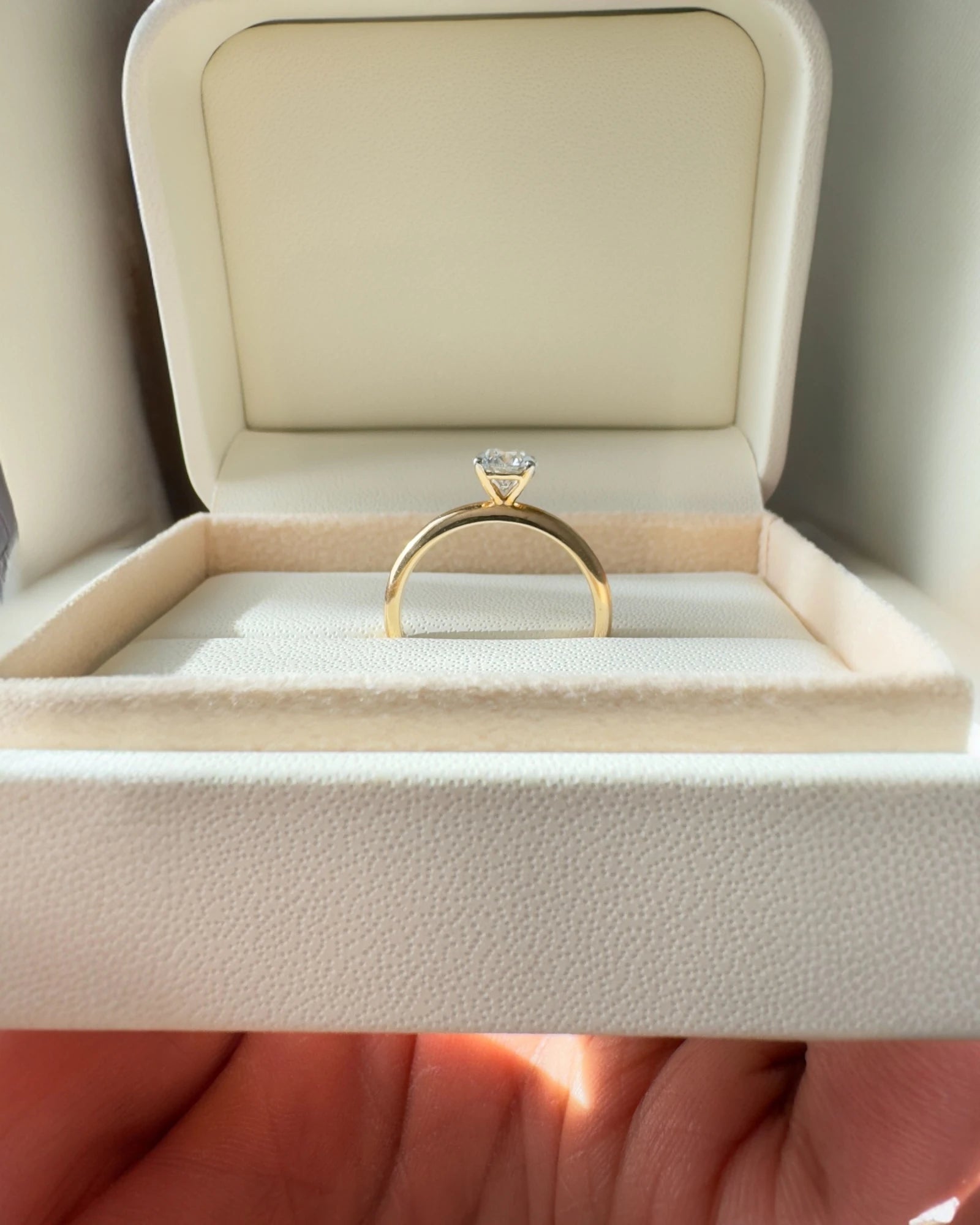 Close up of round brilliant diamond engagement ring.