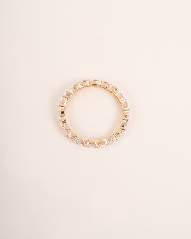 Close up shot of diamond eternity band in yellow gold.