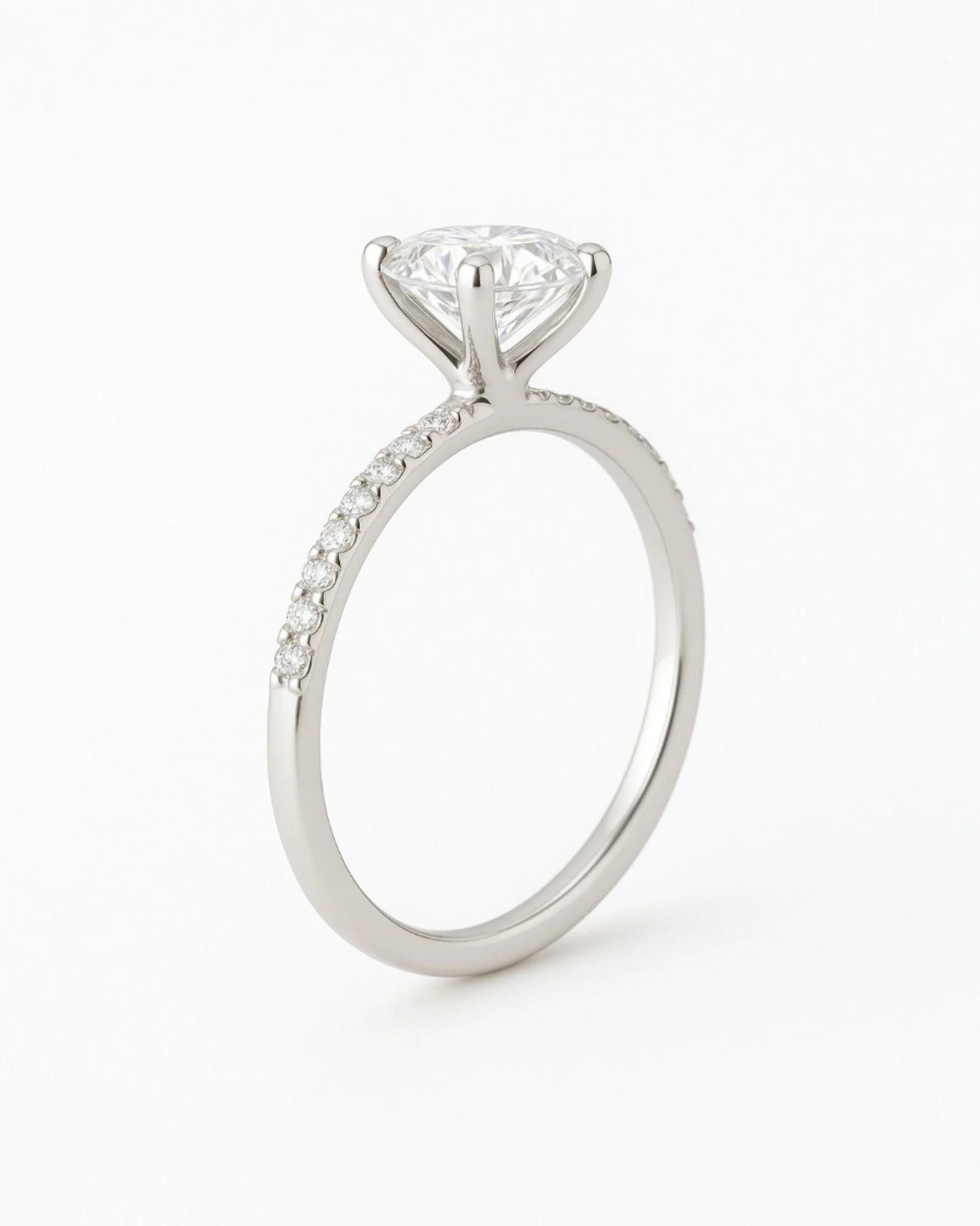 Side view of  round diamond engagement ring with pave band.