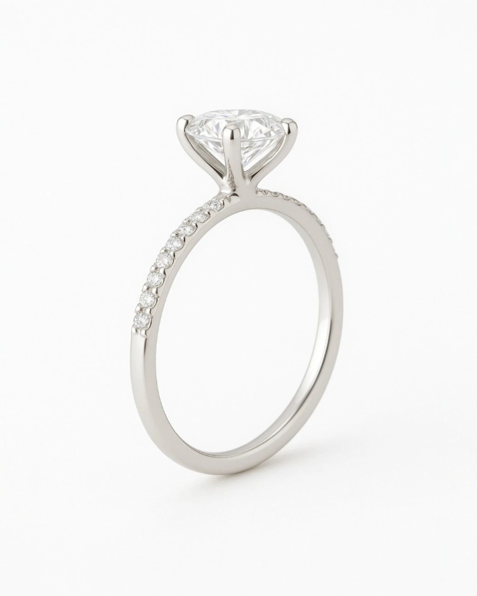 Side view of  round diamond engagement ring with pave band.