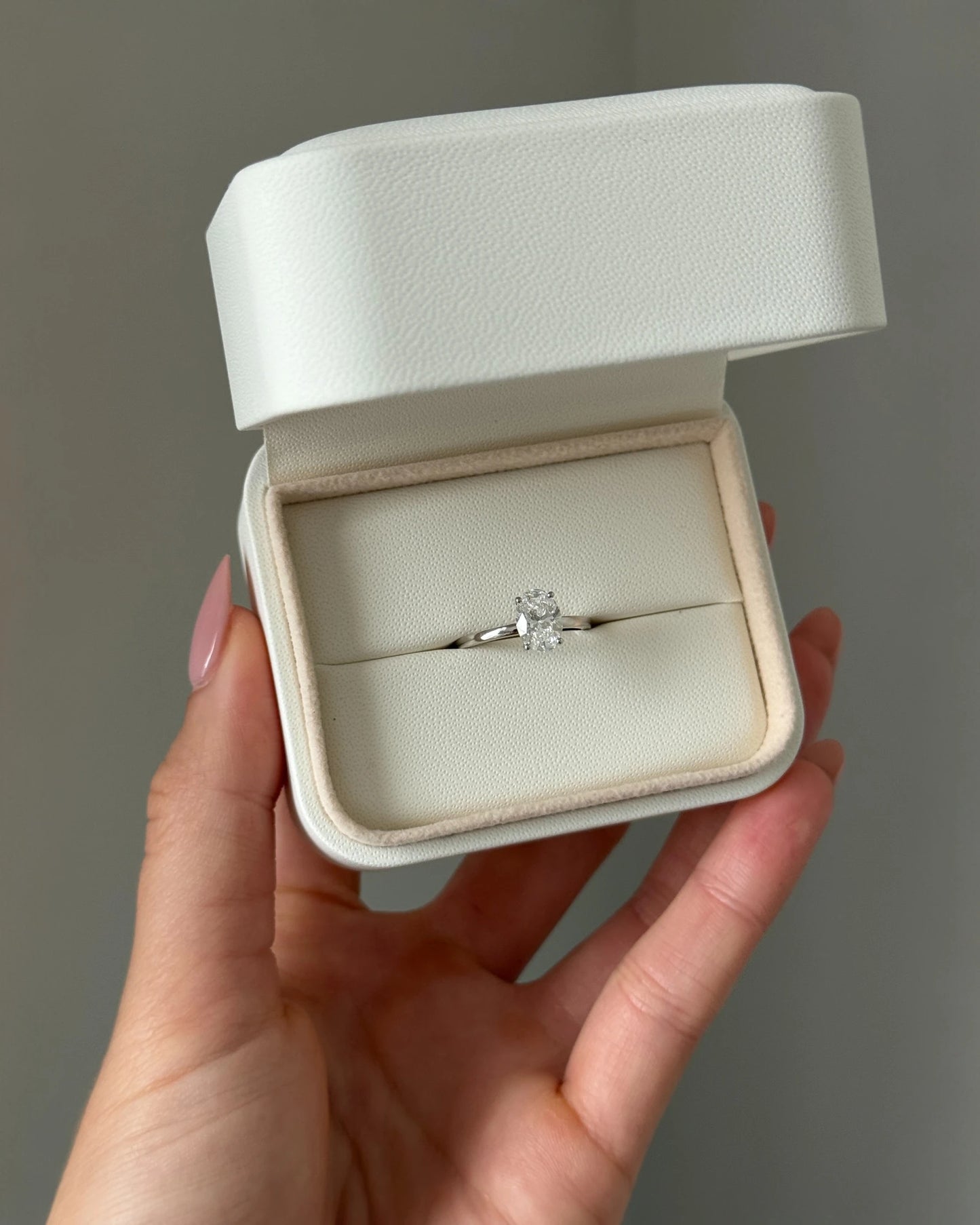 Close up of diamond ring on a neutral background