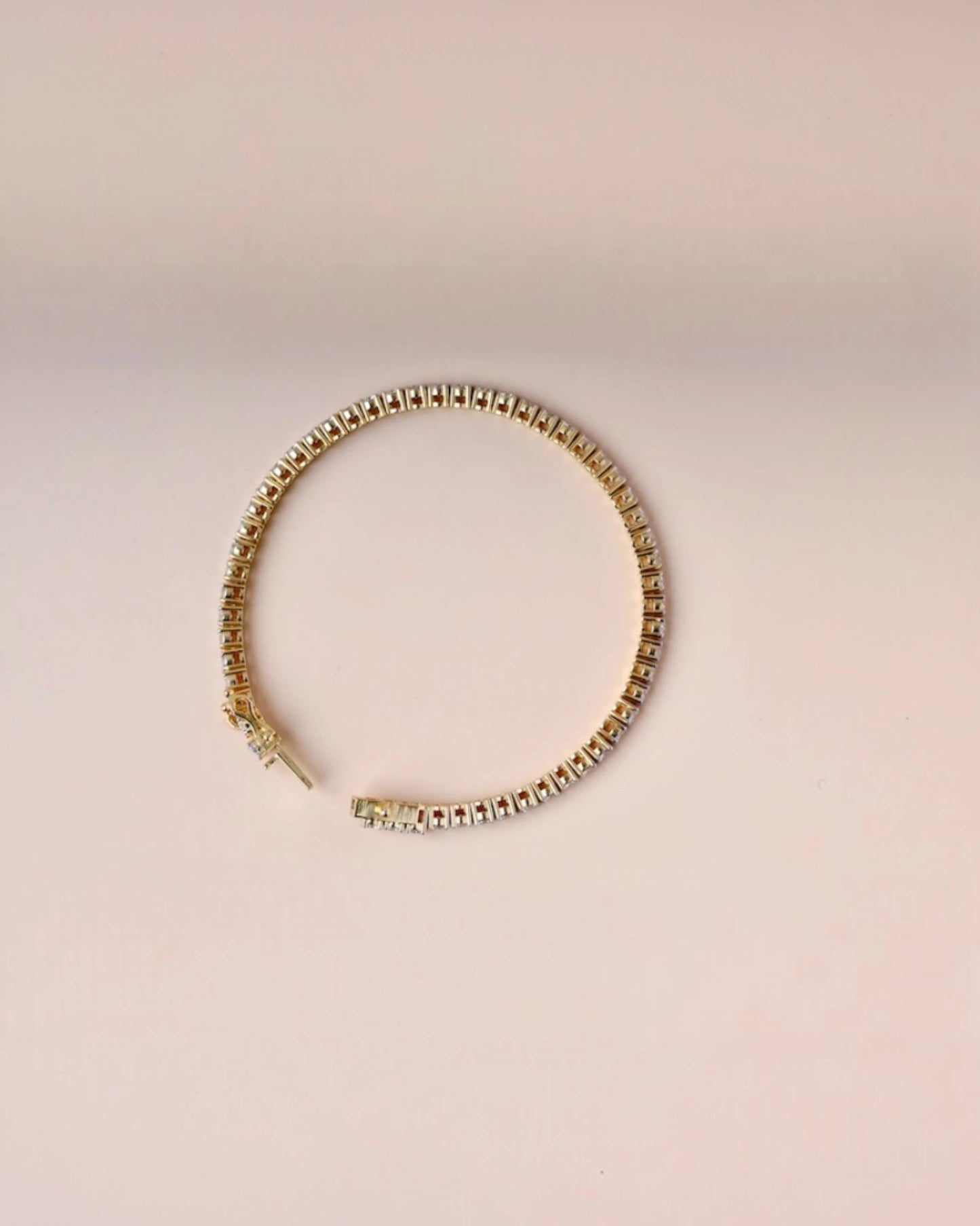 Close up of yellow gold tennis diamond bracelet.