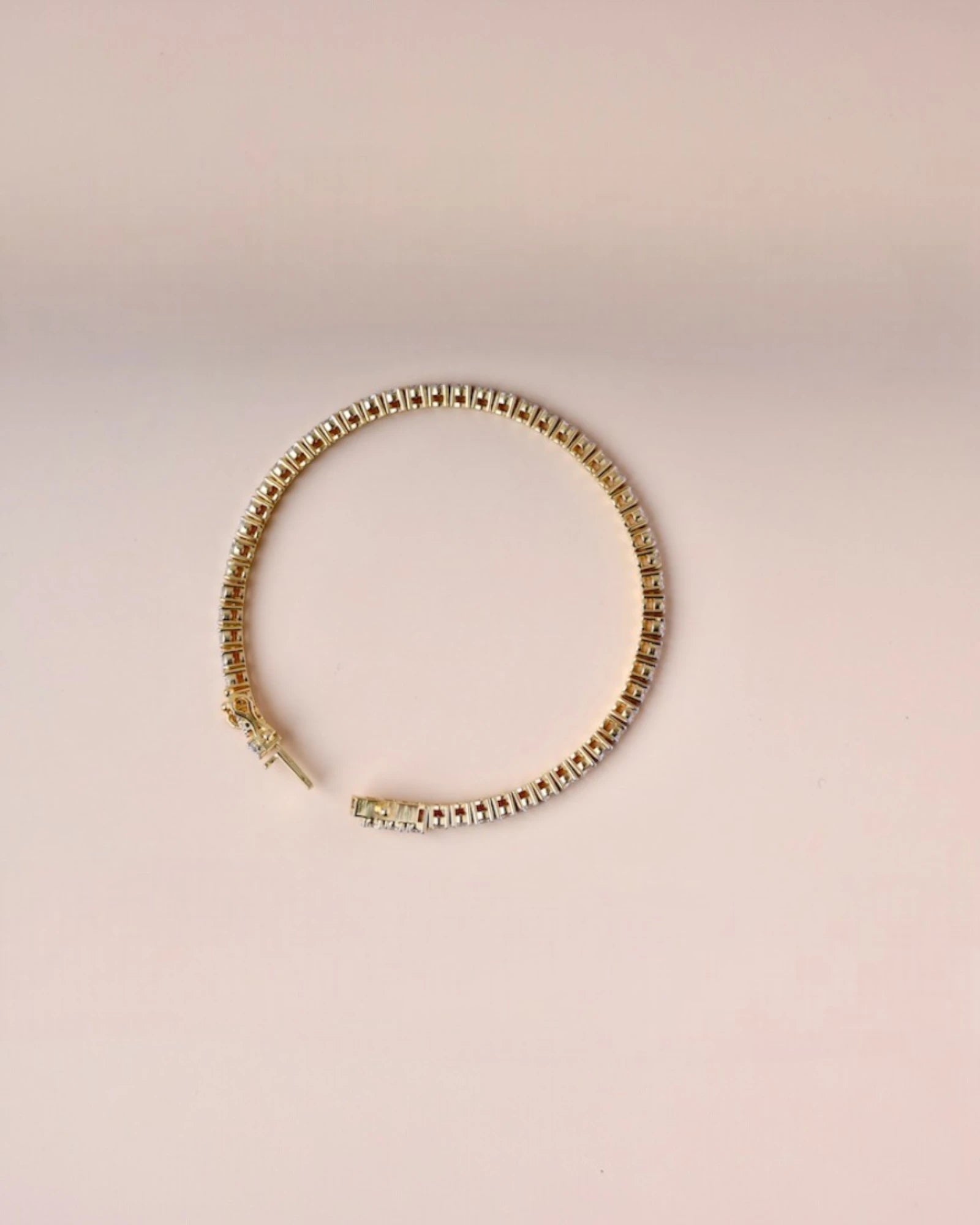 Close up of yellow gold tennis diamond bracelet.