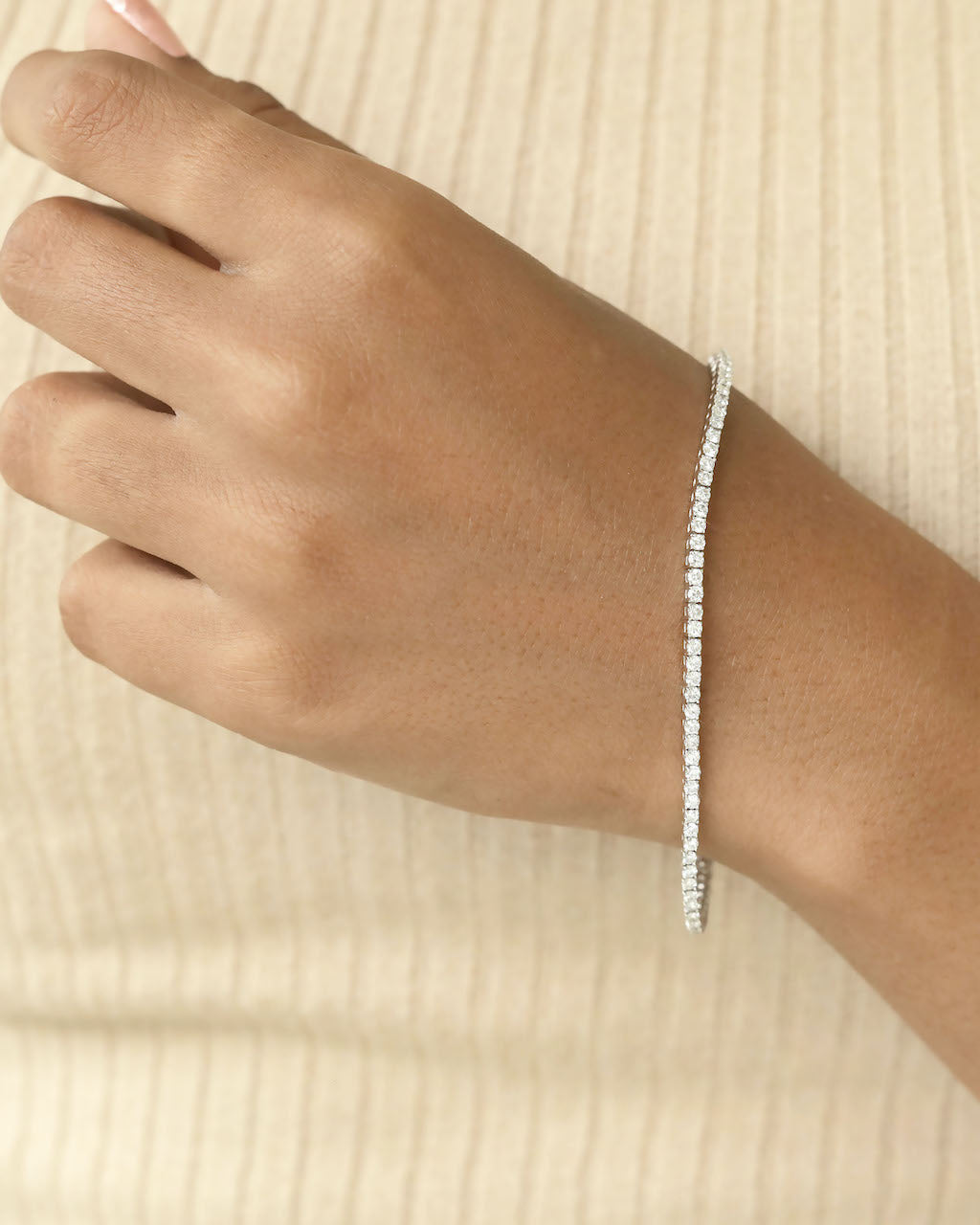 Diamond bracelet on a wrist.