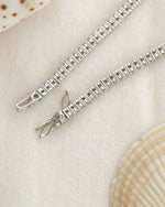 Diamond bracelet on a textured background.