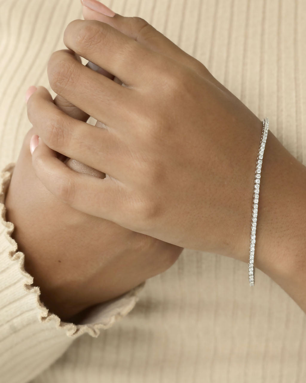 Diamond bracelet on a wrist.