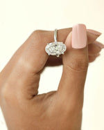 Diamond ring on a hand with a soft focus background