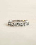 Close up shot of channel set diamond eternity ring in white gold.