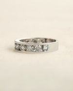 Side view of channel set diamond eternity ring in white gold.