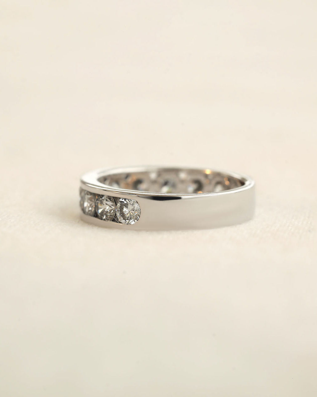 Side view of channel set diamond eternity ring in white gold.
