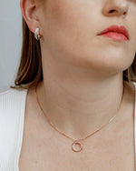 Close up of circle lab grown diamond pendant necklace.
