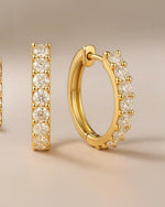  Close up shot of classic pave diamond hoop earrings.