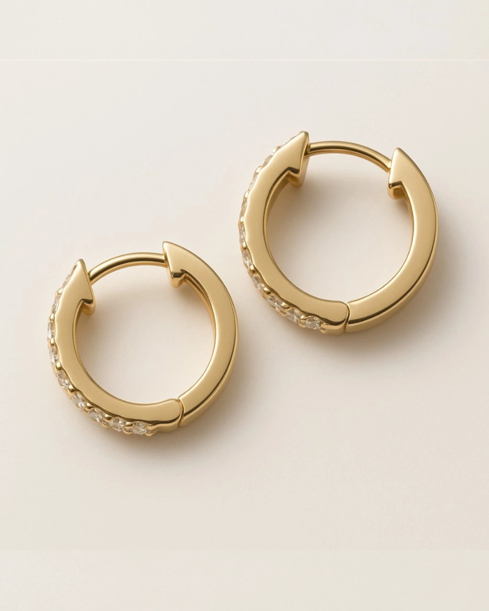  Close up shot of classic pave diamond hoop earrings.
