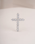 Close up shot of cross diamond pendant in white gold.