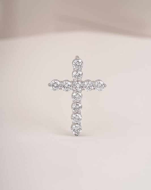 Close up shot of cross diamond pendant in white gold.