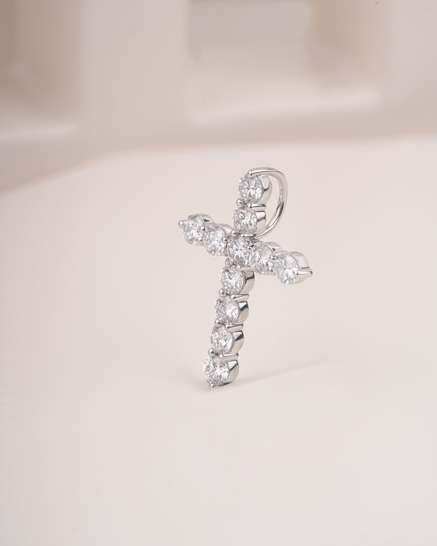 Close up shot of cross diamond pendant in white gold.
