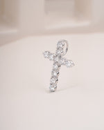 Close up shot of cross diamond pendant in white gold.