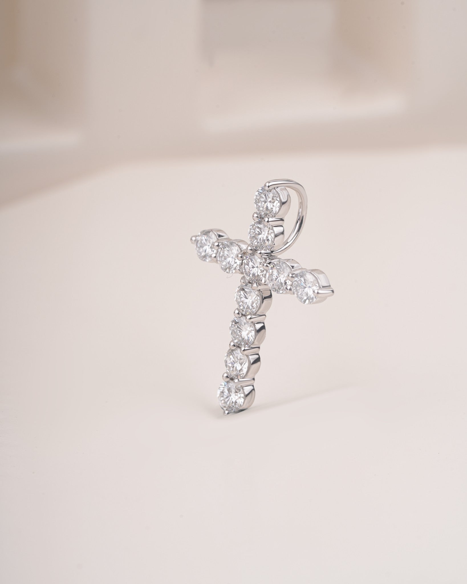 Close up shot of cross diamond pendant in white gold.