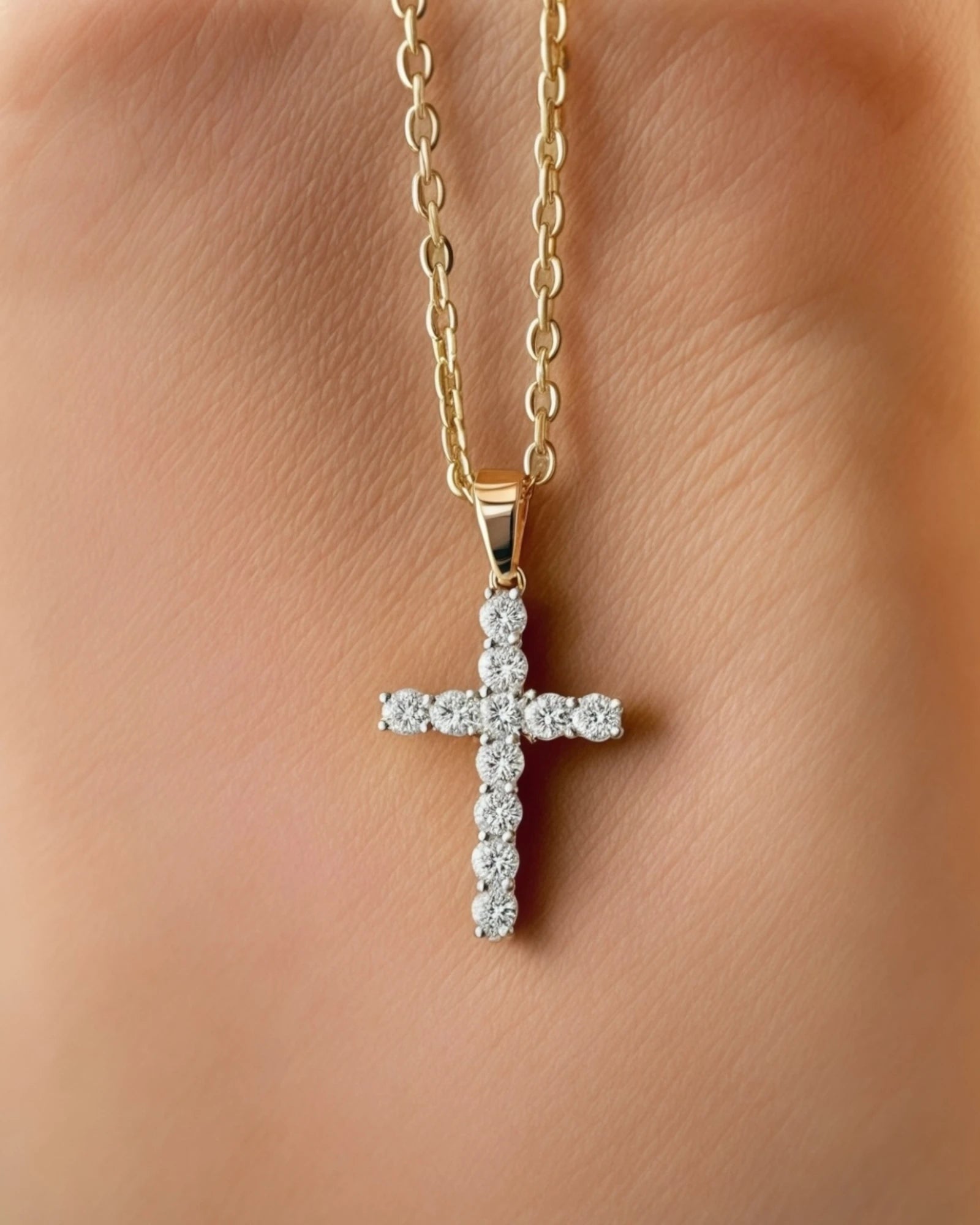 Diamond cross pendant on light rust background.