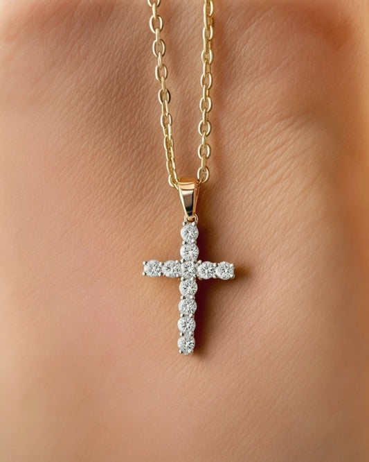 Diamond cross pendant on light rust background.