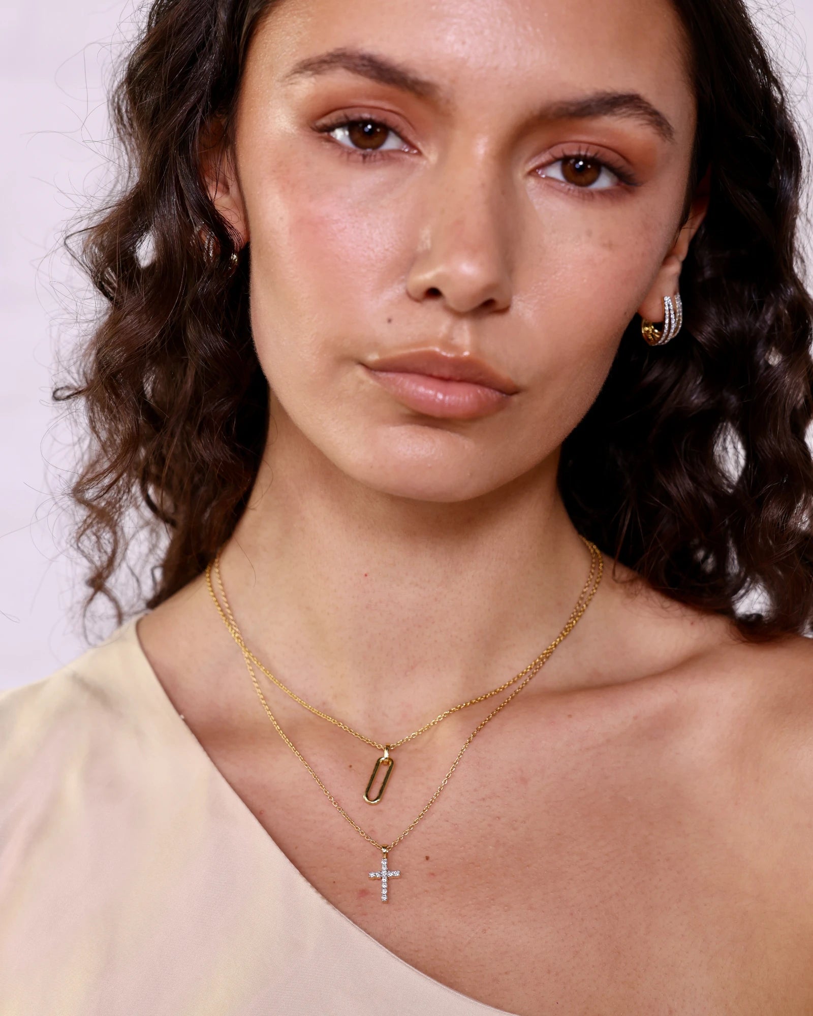 Person wearing diamond cross pendant