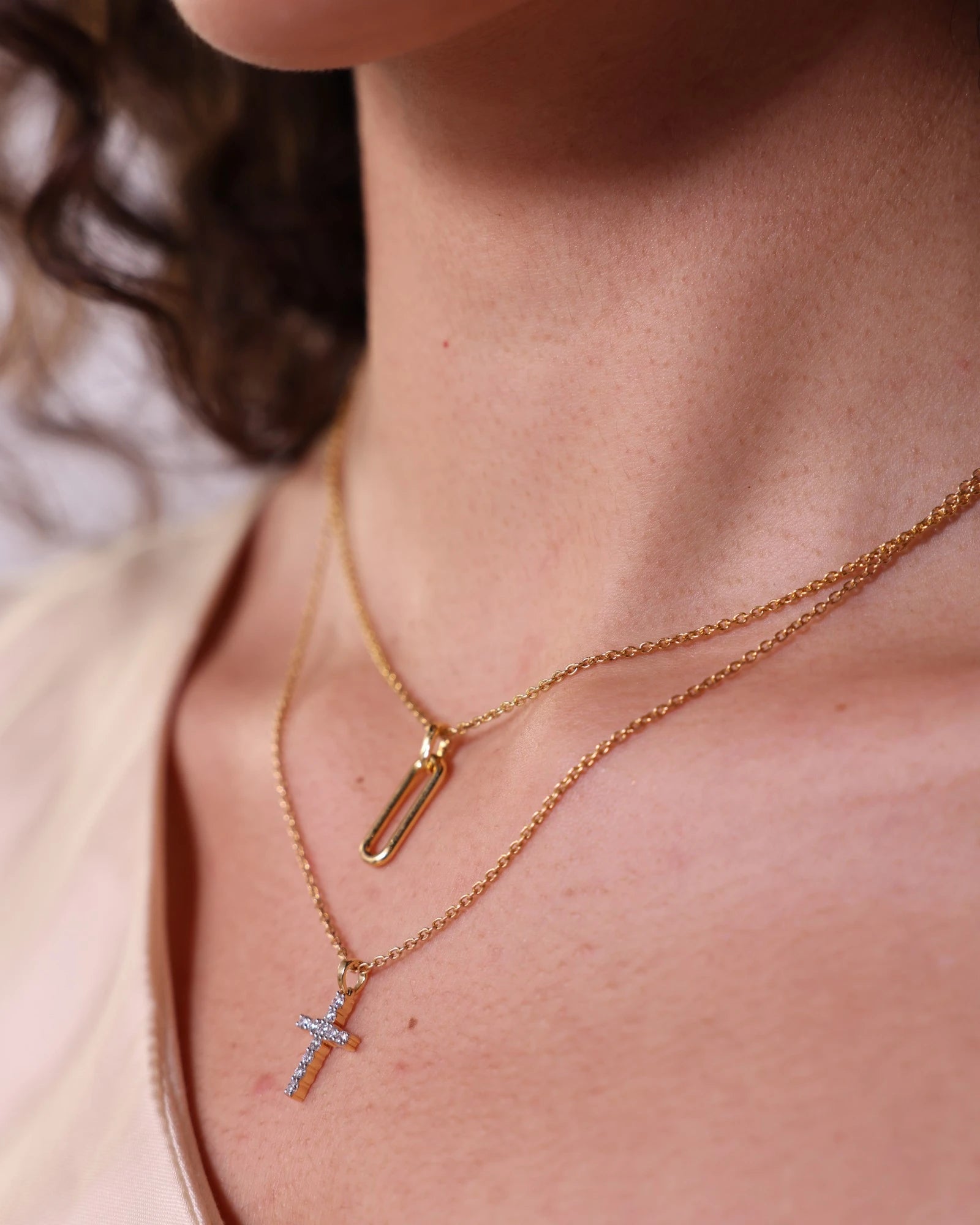Person wearing diamond cross pendant