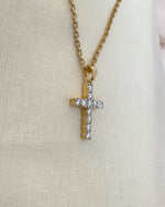 Close up shot of diamond cross pendant.
