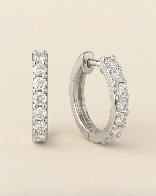 Close up shot of diamond huggie hoop earrings.