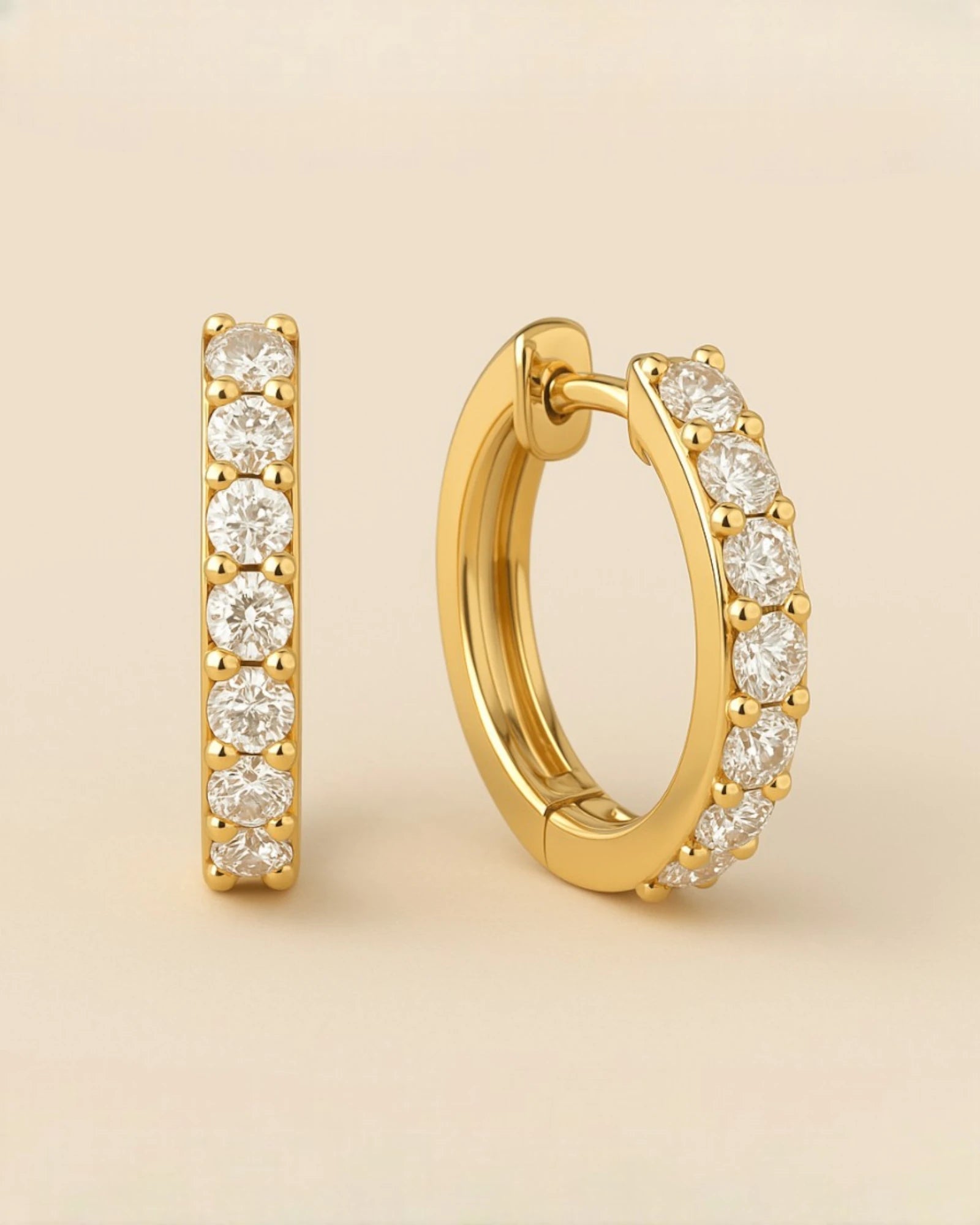 Close up shot of diamond huggie hoop earrings.