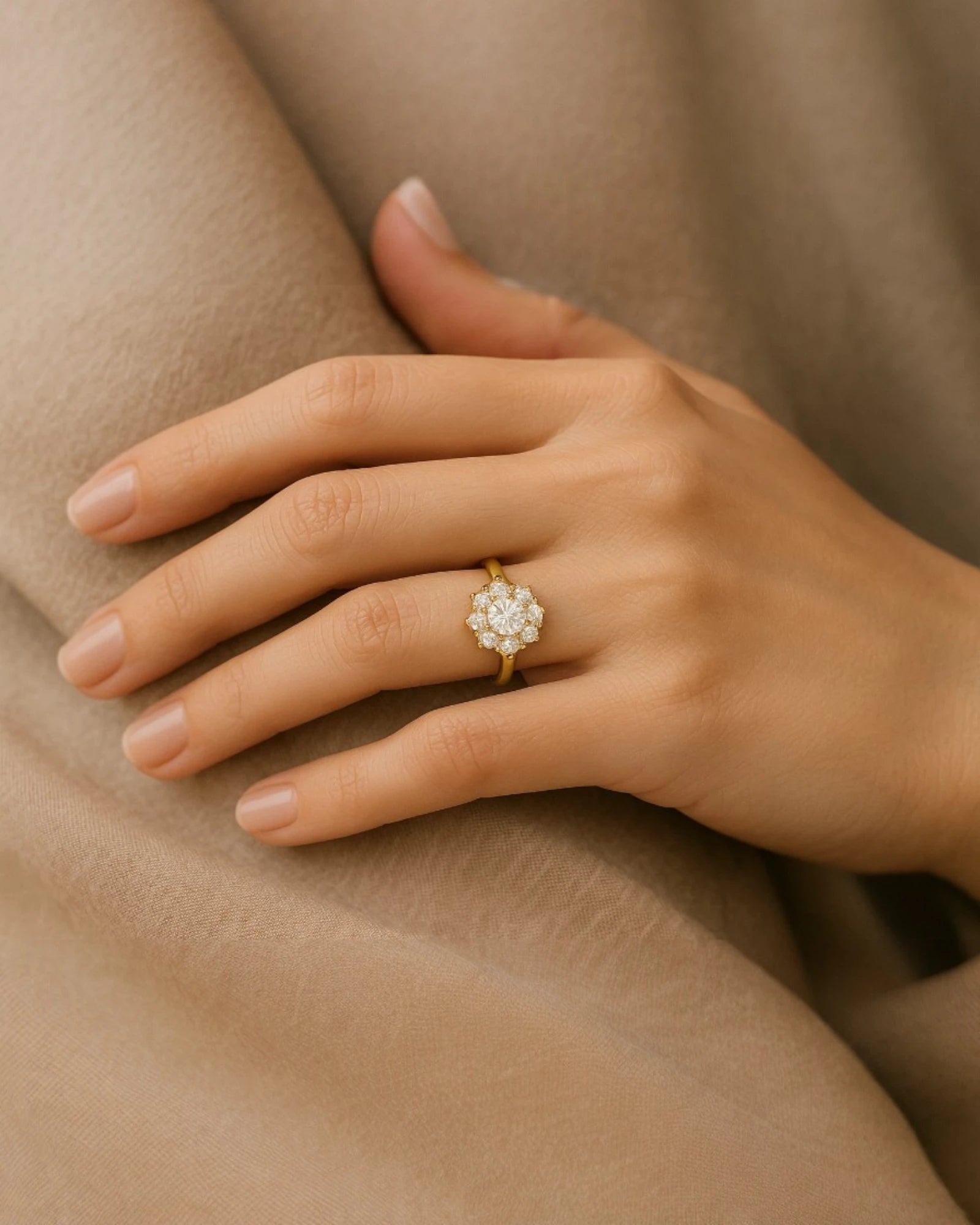 Hand wearing floral halo diamond cluster ring.