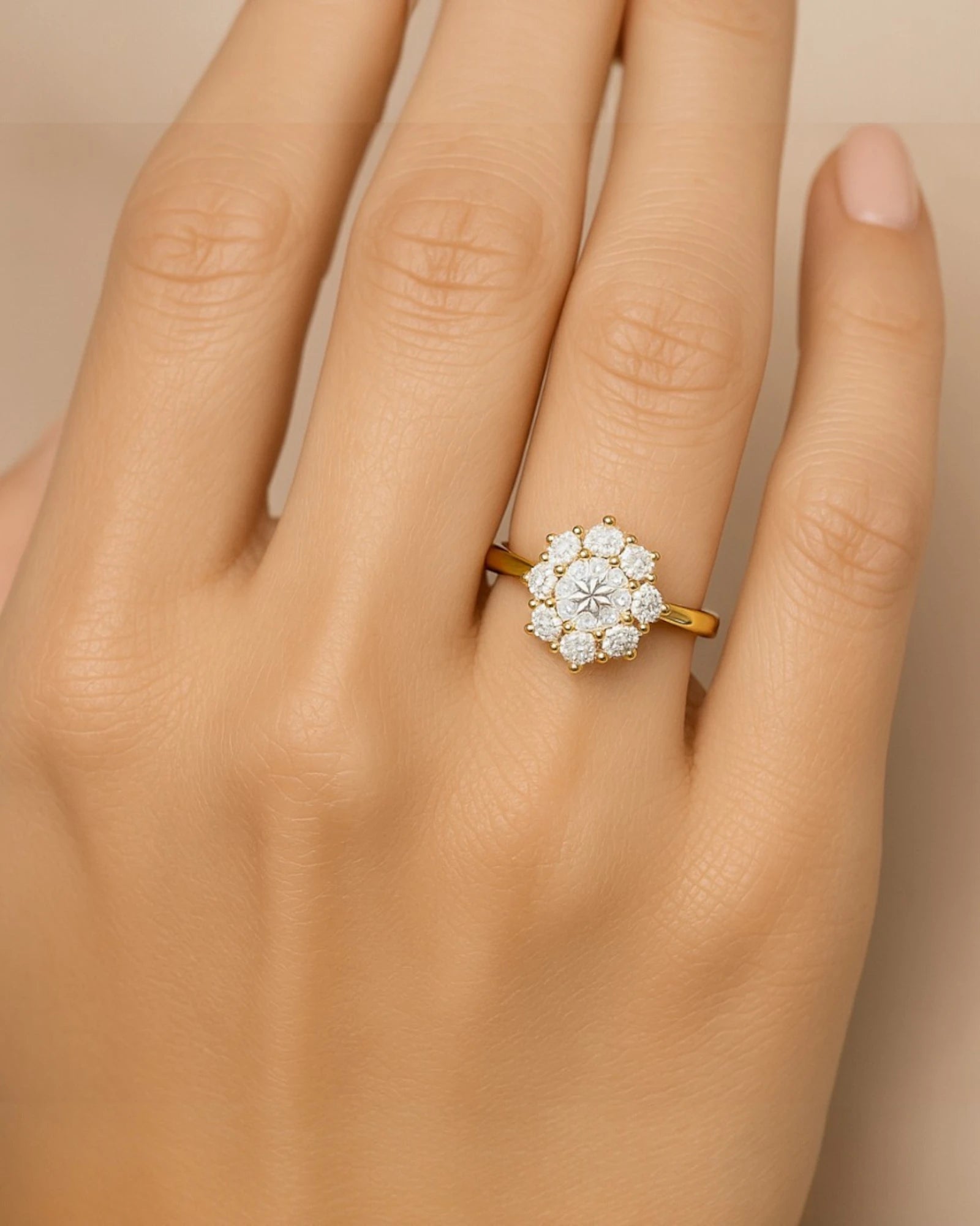 Hand wearing floral halo diamond cluster ring.