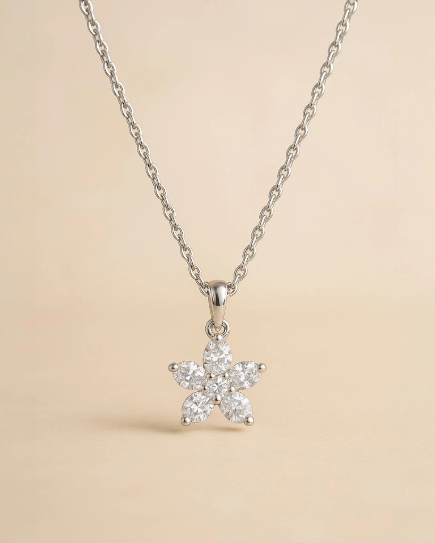 Close up of floral lab diamond pendant with chain .