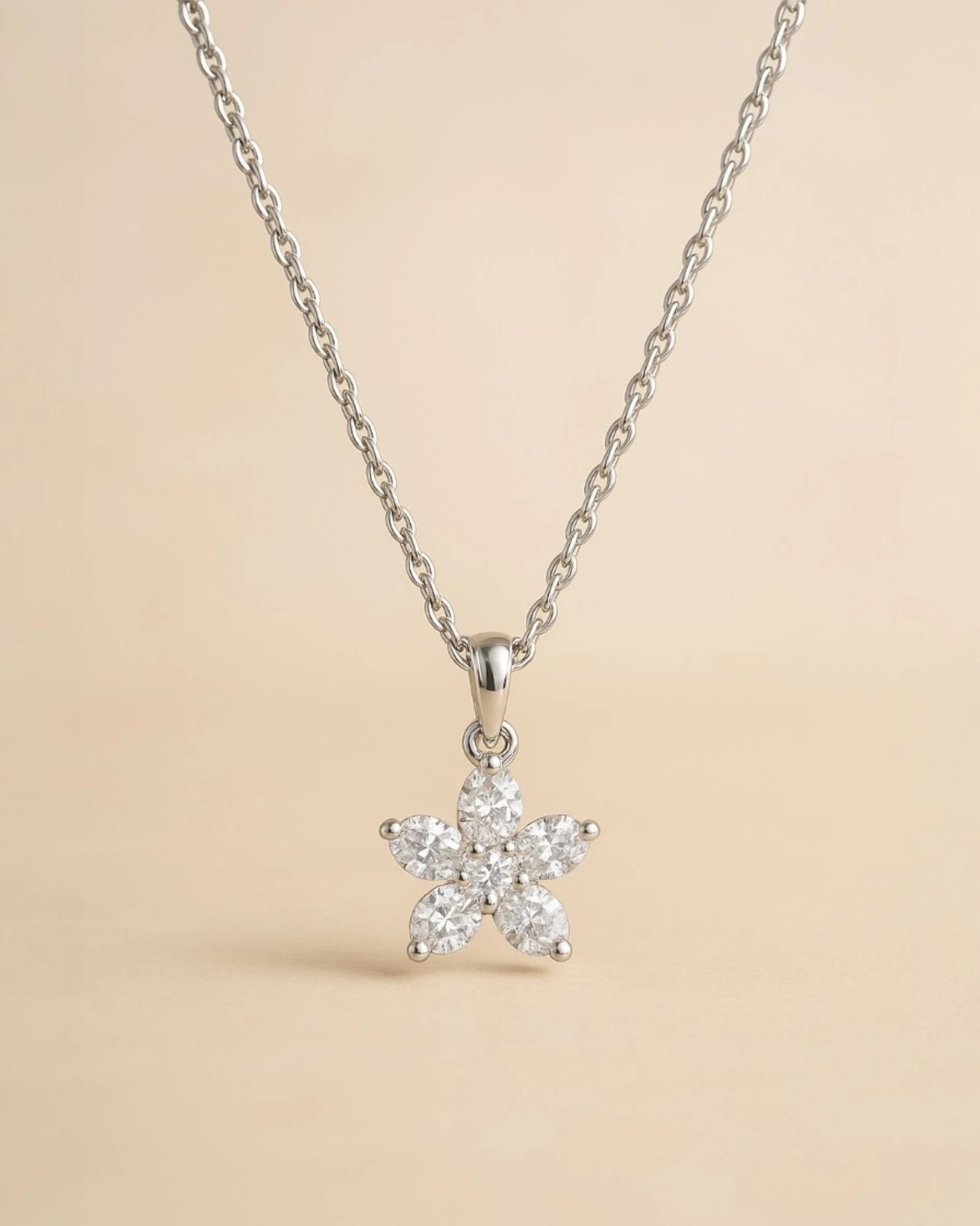 Close up of floral lab diamond pendant with chain .