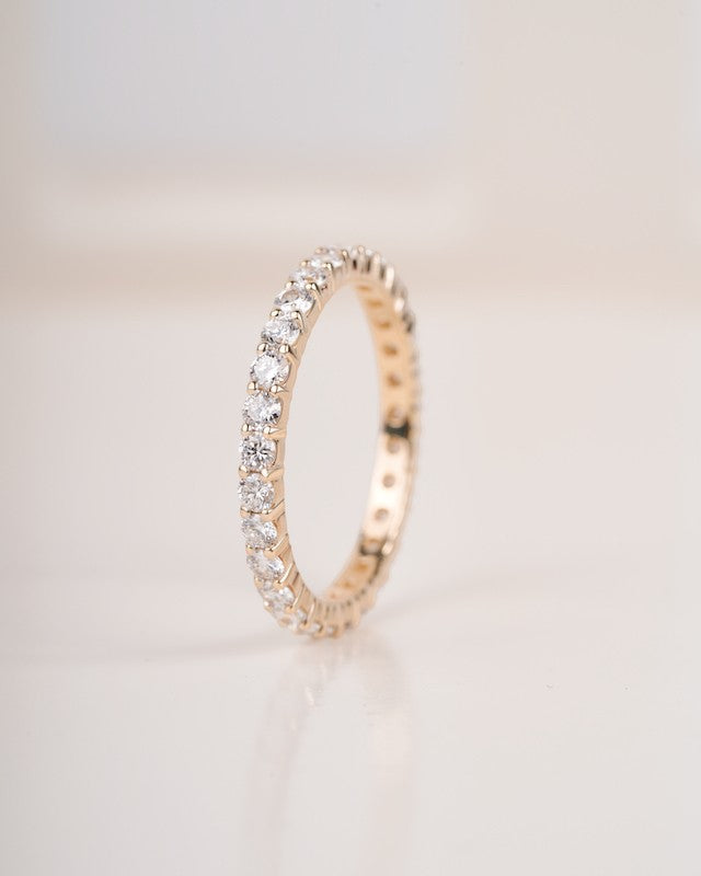  Close up shot of full eternity diamond ring band in yellow gold.