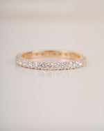  Close up shot of full eternity diamond ring band in yellow gold.