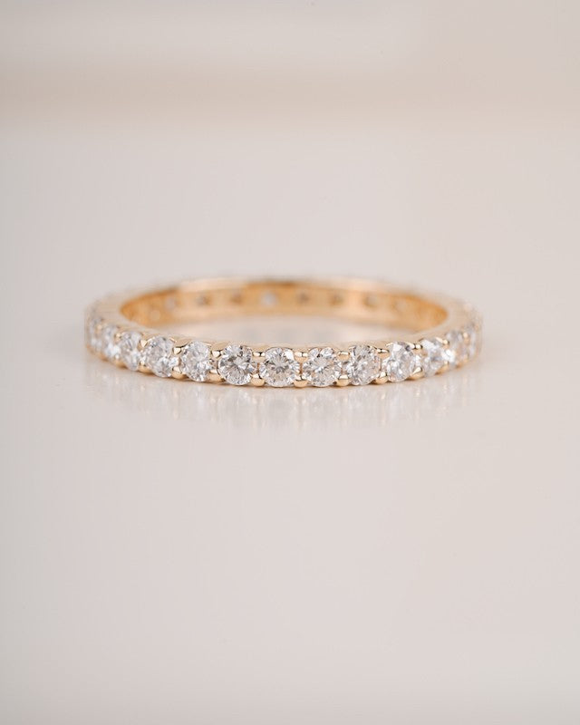  Close up shot of full eternity diamond ring band in yellow gold.