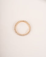  Close up shot of full eternity diamond ring band in yellow gold.