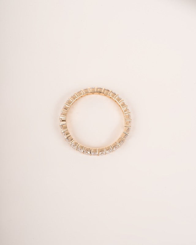  Close up shot of full eternity diamond ring band in yellow gold.