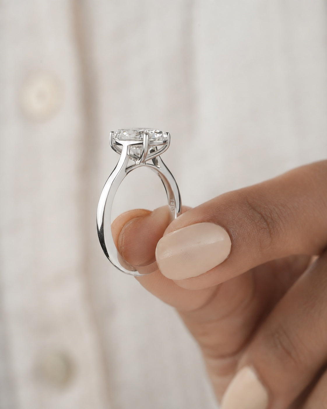 2.00ct oval cut lab grown diamond engagement ring in a cathedral setting, close up detail