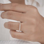 Hand wearing half eternity diamond ring in yellow gold.