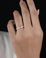 Hand wearing half eternity diamond ring in yellow gold.